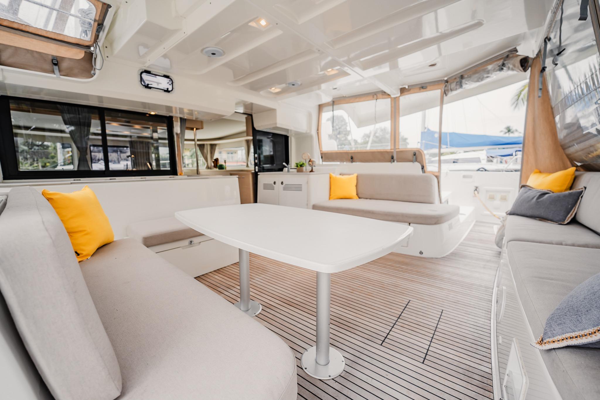 Luxurious interior of 2022 Lagoon 46 catamaran with modern seating and decor.
