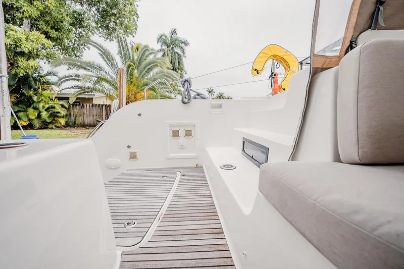  Yacht Photos Pics 2022 Lagoon 46 yacht deck with seating, showcasing modern design and lush surroundings.