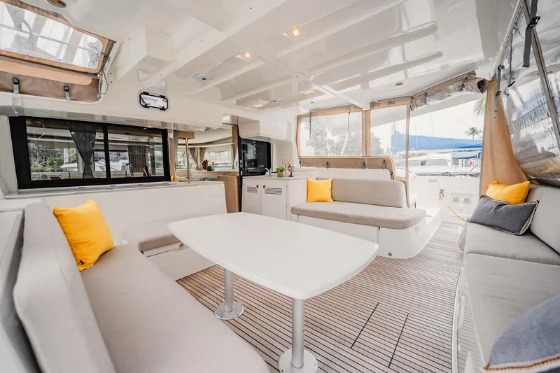  Yacht Photos Pics Luxurious interior of 2022 Lagoon 46 catamaran with modern seating and bright accents.