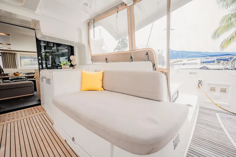  Yacht Photos Pics Luxurious 2022 Lagoon 46 yacht interior with cozy seating and elegant decor.