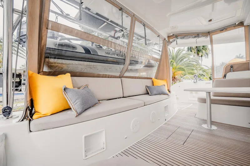  Yacht Photos Pics Luxurious Lagoon 46 catamaran interior with cozy seating and vibrant cushions, 2022 model.