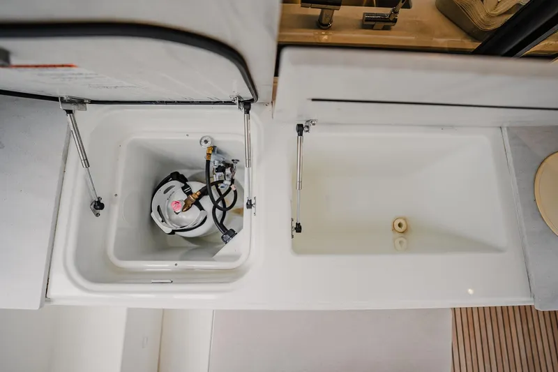  Yacht Photos Pics Storage compartments on a 2022 Lagoon 46 yacht, featuring a propane tank and empty space.
