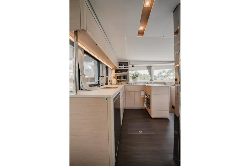  Yacht Photos Pics Modern interior of 2022 Lagoon 46 yacht with sleek kitchen design.