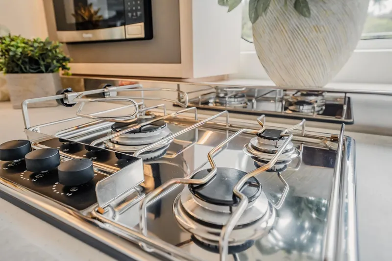  Yacht Photos Pics Modern kitchen stove in 2022 Lagoon 46 yacht, featuring sleek stainless steel design.