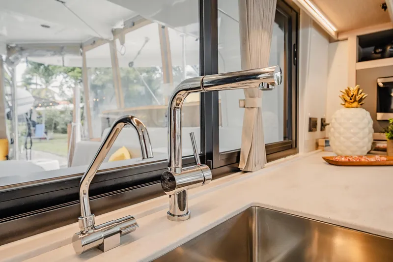  Yacht Photos Pics Modern kitchen sink with chrome faucets in 2022 Lagoon 46 yacht interior.