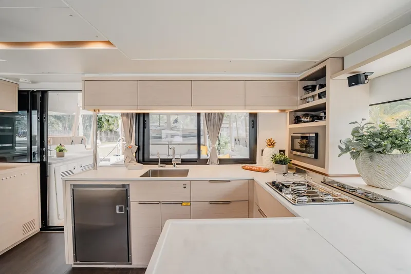 Yacht Photos Pics Modern kitchen interior of 2022 Lagoon 46 yacht with sleek design and appliances.