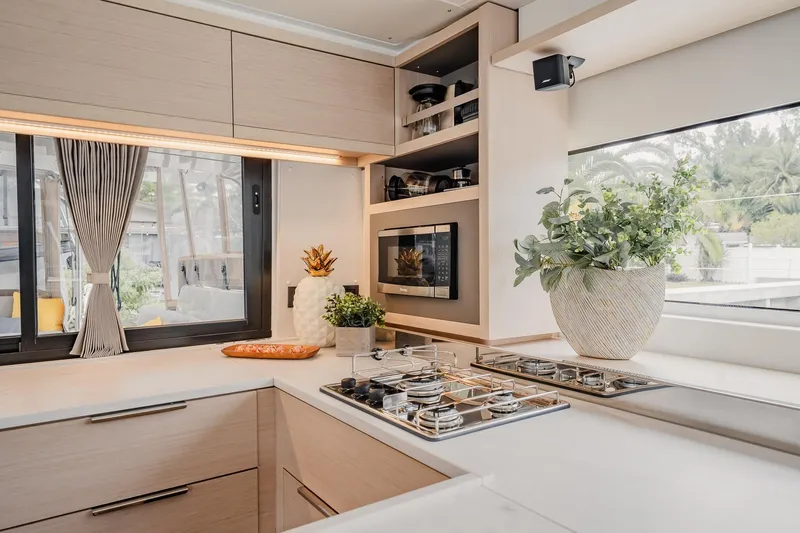  Yacht Photos Pics Modern kitchen interior of 2022 Lagoon 46 yacht with sleek design and large windows.