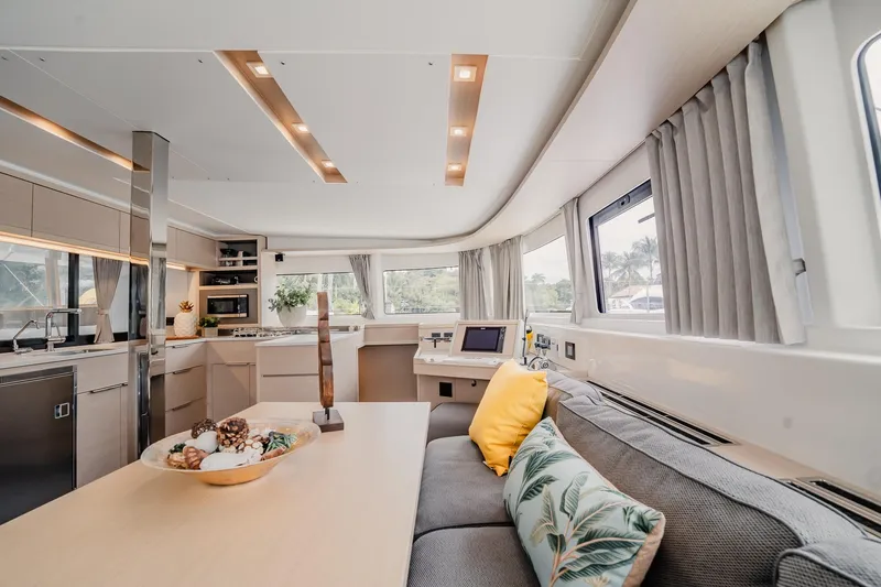  Yacht Photos Pics Luxurious interior of 2022 Lagoon 46 yacht with modern kitchen and cozy seating area.