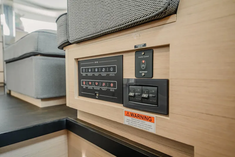  Yacht Photos Pics Control panel on 2022 Lagoon 46 yacht interior, featuring switches and warning label.