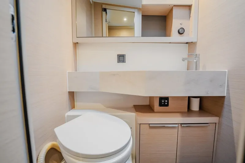  Yacht Photos Pics Modern bathroom in 2022 Lagoon 46 yacht with sleek fixtures and storage.