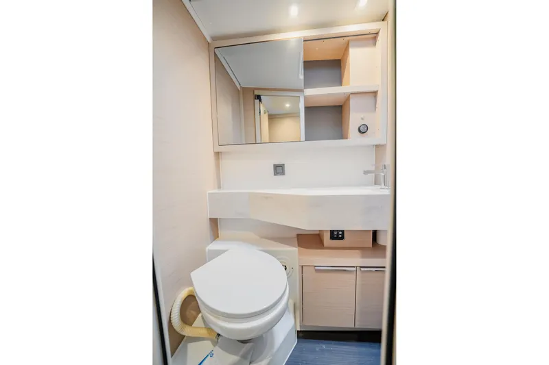  Yacht Photos Pics Modern bathroom in 2022 Lagoon 46 yacht with sleek fixtures and ample storage.