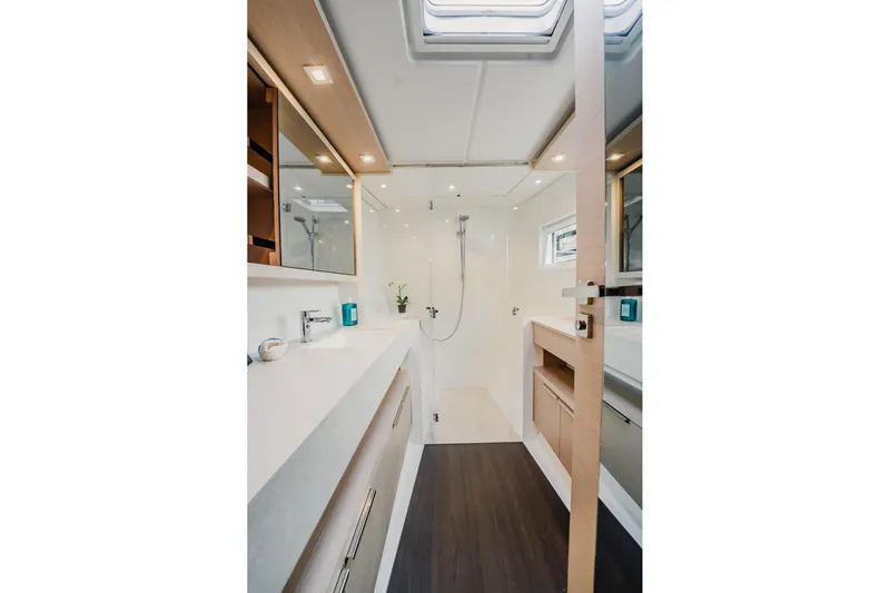  Yacht Photos Pics Luxurious bathroom interior of 2022 Lagoon 46 yacht with modern fixtures and elegant design.