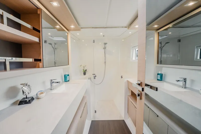  Yacht Photos Pics Luxurious bathroom interior of 2022 Lagoon 46 yacht with modern fixtures and elegant design.