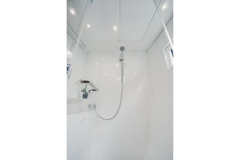  Yacht Photos Pics Modern shower area in 2022 Lagoon 46 yacht, featuring sleek design and bright lighting.