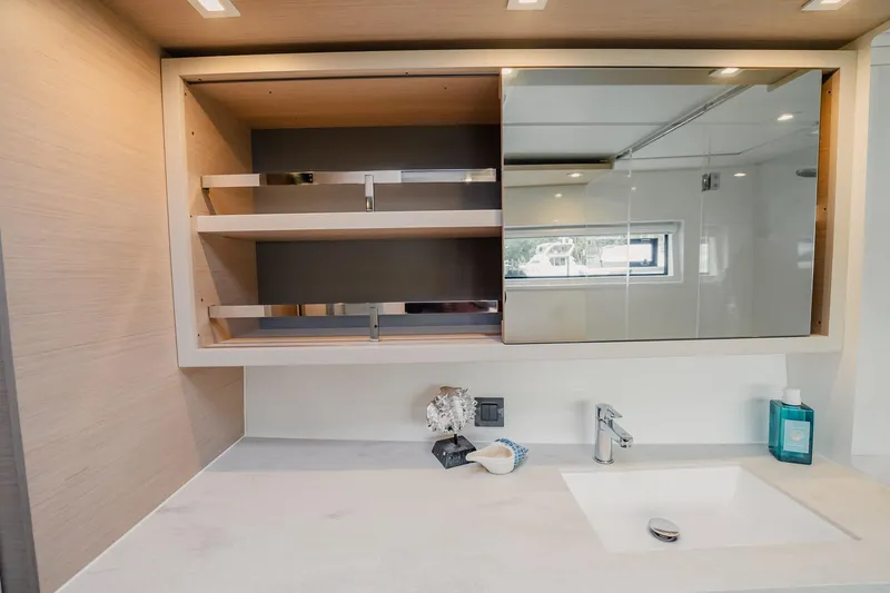  Yacht Photos Pics Modern bathroom vanity in 2022 Lagoon 46 yacht with open shelving and sleek design.