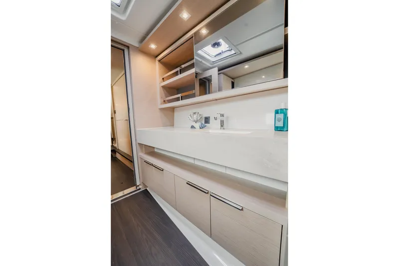  Yacht Photos Pics Modern bathroom interior of 2022 Lagoon 46 yacht with sleek design and ample storage.