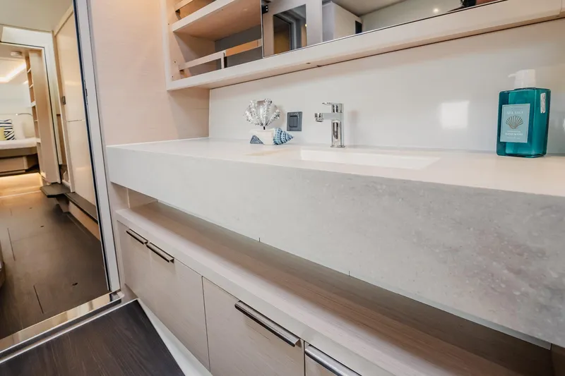 Yacht Photos Pics Modern bathroom interior of 2022 Lagoon 46 yacht with sleek sink and storage.