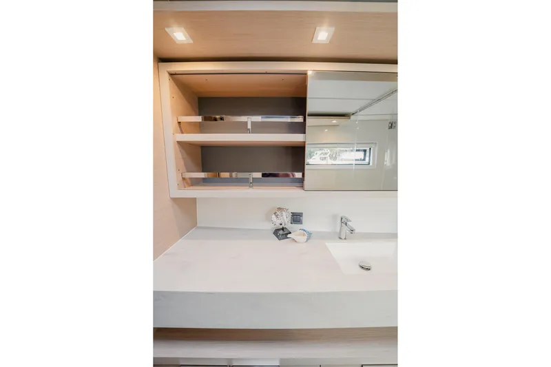  Yacht Photos Pics Modern bathroom interior of 2022 Lagoon 46 yacht with sleek sink and shelving.