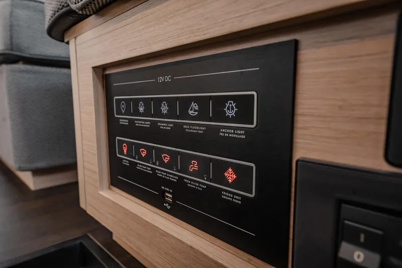  Yacht Photos Pics Control panel of 2022 Lagoon 46 yacht, featuring 12V DC system and various function indicators.
