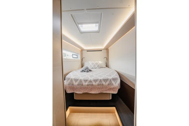  Yacht Photos Pics Luxurious bedroom interior of 2022 Lagoon 46 yacht with modern design and cozy bedding.