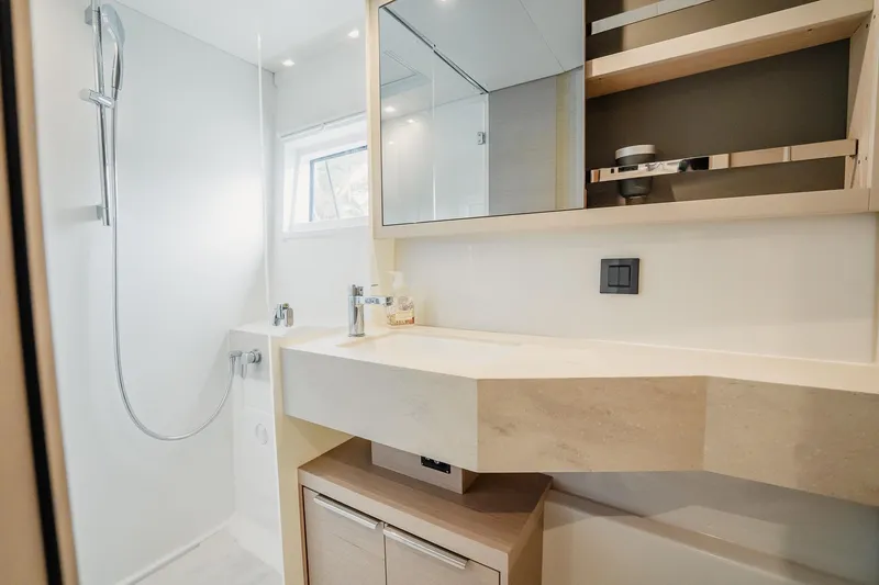  Yacht Photos Pics Modern bathroom in 2022 Lagoon 46 yacht with sleek fixtures and ample storage.