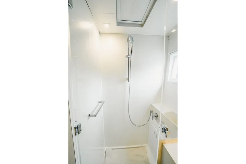  Yacht Photos Pics Modern shower area in 2022 Lagoon 46 yacht, featuring sleek design and fixtures.