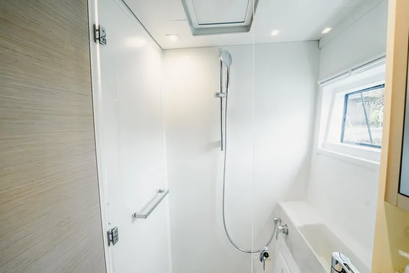  Yacht Photos Pics Modern shower area in 2022 Lagoon 46 yacht, featuring sleek design and natural lighting.