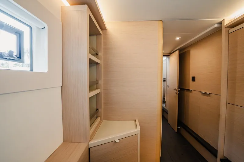  Yacht Photos Pics Interior of 2022 Lagoon 46 yacht, featuring modern wood cabinetry and sleek design.