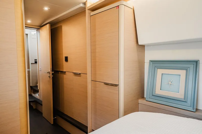 Yacht Photos Pics Interior of 2022 Lagoon 46 yacht with modern wood finish and starfish artwork.