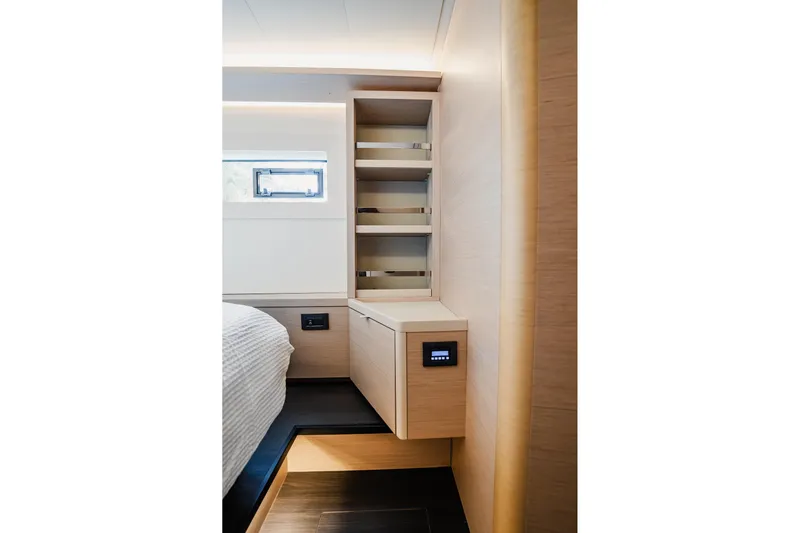  Yacht Photos Pics Modern interior of 2022 Lagoon 46 yacht with sleek wooden cabinetry and shelving.