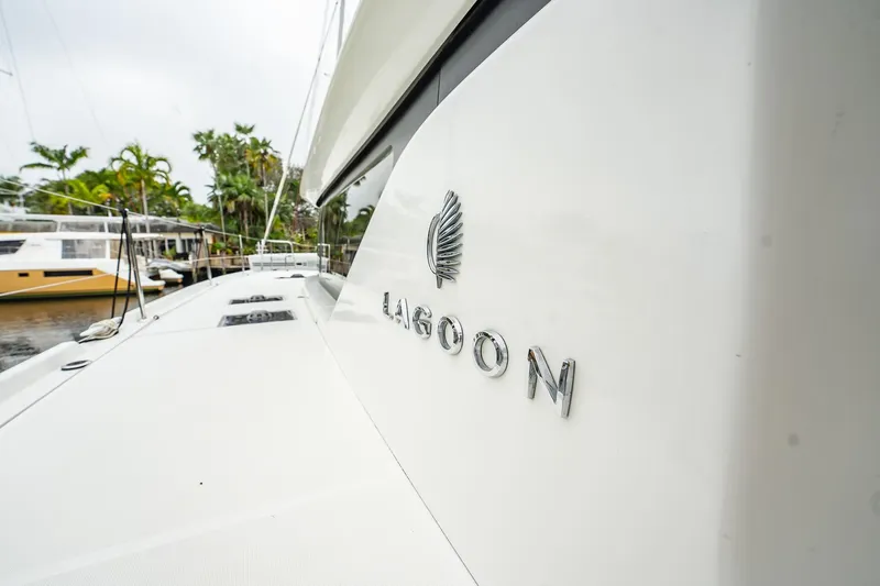  Yacht Photos Pics 2022 Lagoon 46 catamaran docked, showcasing sleek design and branding.