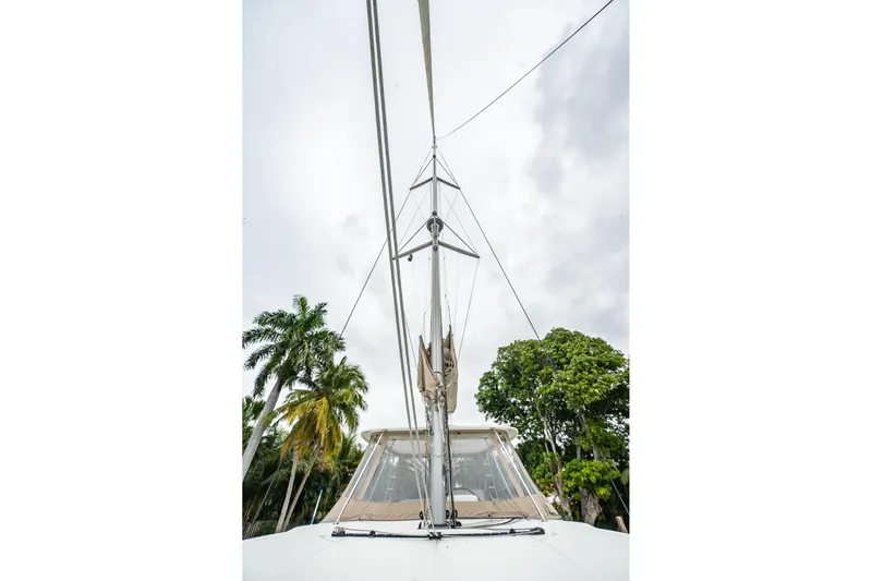  Yacht Photos Pics 2022 Lagoon 46 catamaran mast with tropical trees in background.