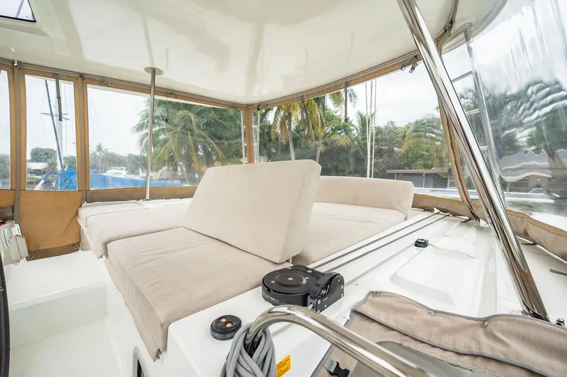 Yacht Photos Pics Interior of 2022 Lagoon 46 catamaran with beige seating and panoramic windows.