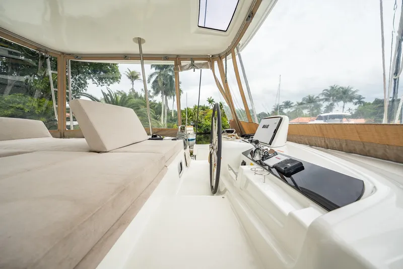  Yacht Photos Pics Luxurious interior of 2022 Lagoon 46 catamaran with plush seating and modern navigation equipment.