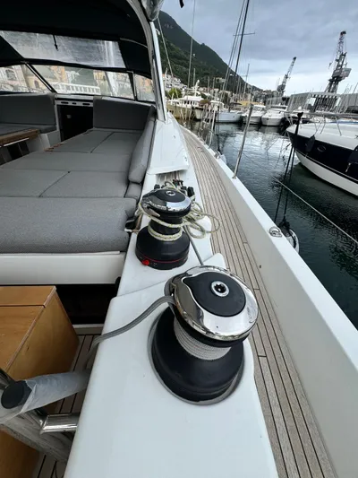 Blue Art Yacht Photos Pics 2023 Jeanneau 65 yacht deck with winches, docked in a marina.