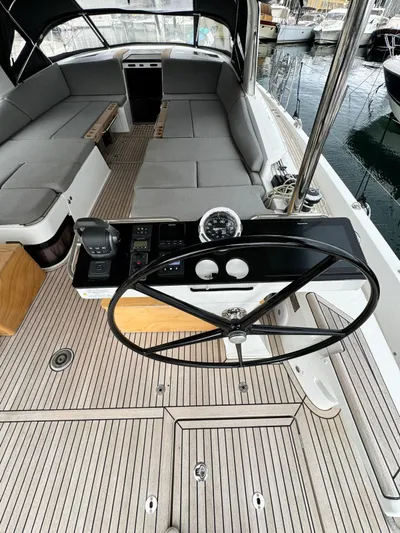 Blue Art Yacht Photos Pics 2023 Jeanneau 65 yacht cockpit with steering wheel and seating area.