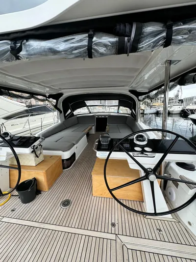 Blue Art Yacht Photos Pics 2023 Jeanneau 65 yacht interior with dual steering wheels and spacious seating area.