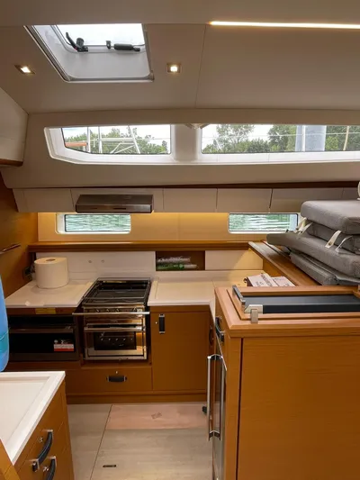 Blue Art Yacht Photos Pics Interior of 2023 Jeanneau 65 yacht kitchen with modern appliances and natural light.