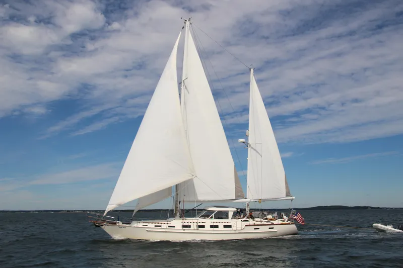 Pacific High Yacht Photos Pics Sailing yacht on open water, Custom 62 model, 1983, with white sails against a blue sky.