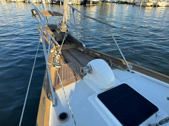 Pacific High Yacht Photos Pics Sailboat deck with wooden finish, Custom 62 model, 1983, docked at marina.