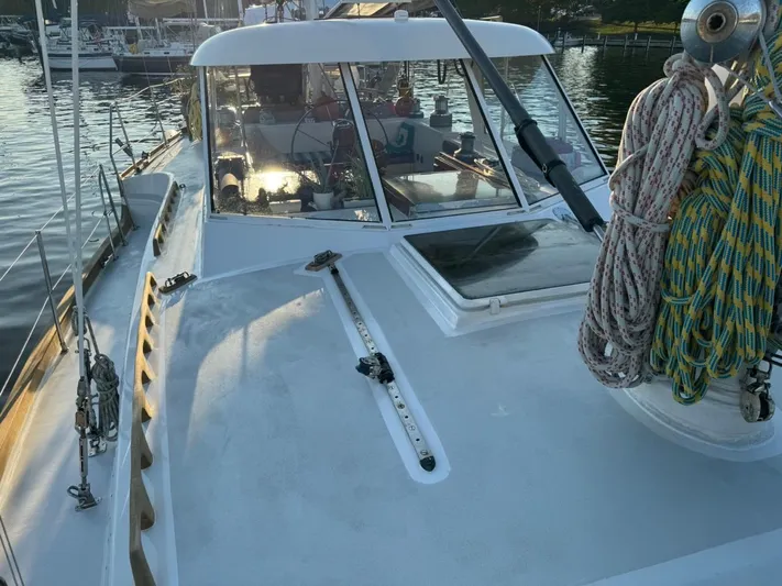 Pacific High Yacht Photos Pics Custom 1983 model 62 yacht deck with ropes, docked in a marina.