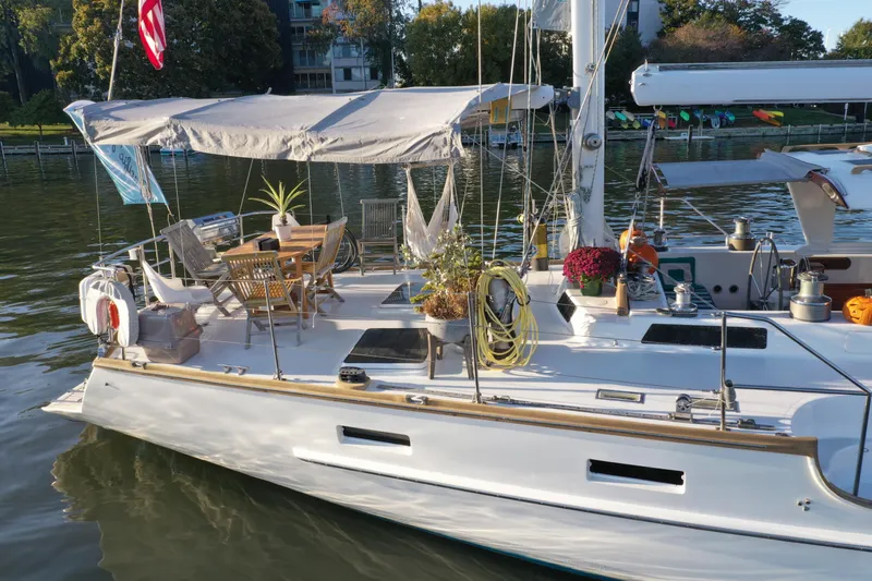 Pacific High Yacht Photos Pics Sailboat with deck seating and plants, Custom 62 model, 1983, docked on calm water.
