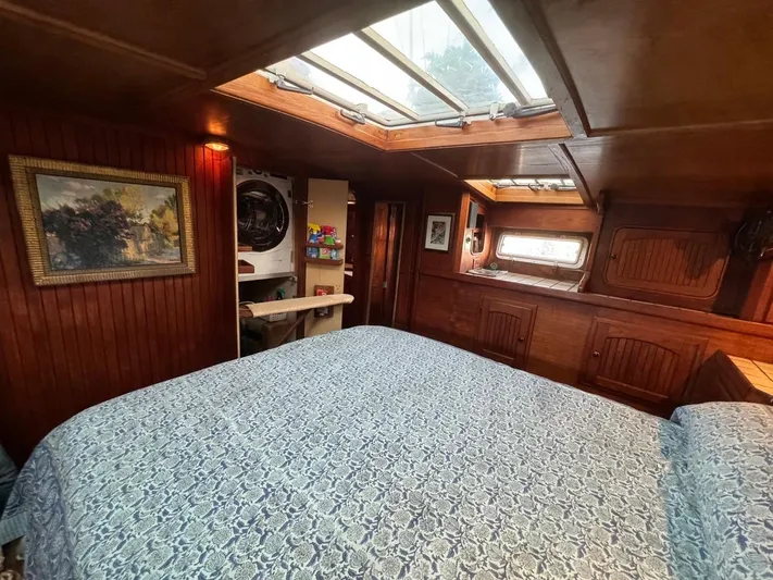 Pacific High Yacht Photos Pics Cozy 1983 Custom 62 yacht interior with skylight, bed, and wooden paneling.