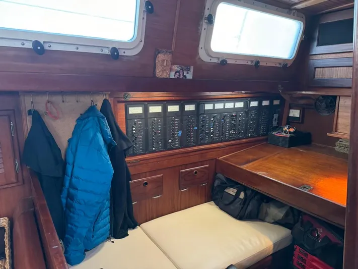 Pacific High Yacht Photos Pics Interior of a 1983 Custom 62 boat with control panels and seating area.