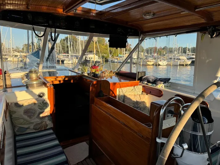 Pacific High Yacht Photos Pics Interior of a 1983 Custom 62 yacht with wooden finishes, docked at a marina.