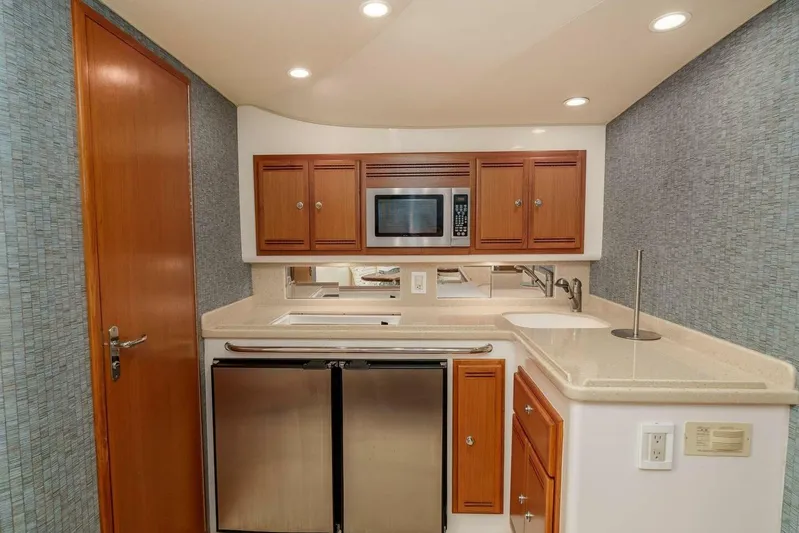 Show Time Yacht Photos Pics 2008 Cabo Yachts 38 EXPRESS kitchen with wood cabinets, stainless appliances, and modern design.