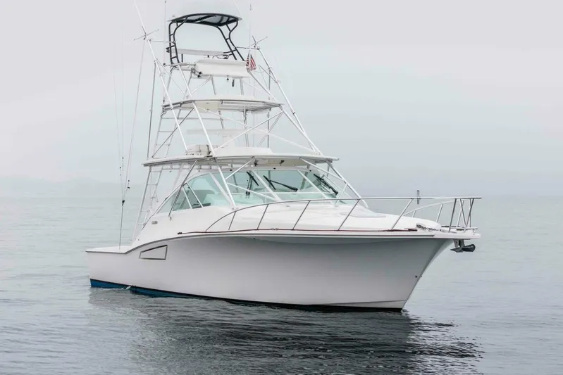 Show Time Yacht Photos Pics 2008 Cabo Yachts 38 EXPRESS boat on calm water, featuring a sleek design and tower.