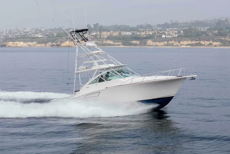 Show Time Yacht Photos Pics 2008 Cabo Yachts 38 EXPRESS cruising on calm waters near a scenic coastline.
