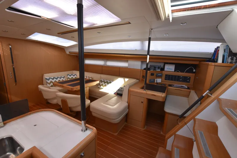 Lady Evelina Yacht Photos Pics Luxurious interior of a 2010 Jeanneau 57 yacht with elegant seating and modern amenities.