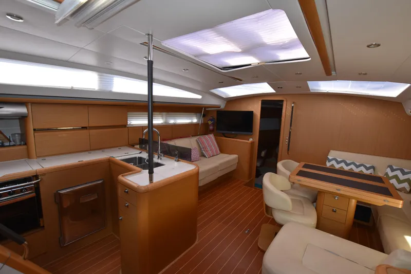 Lady Evelina Yacht Photos Pics Luxurious interior of 2010 Jeanneau 57 yacht with modern kitchen and seating area.
